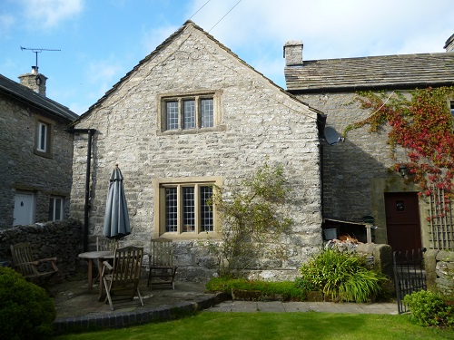 The cottage's gable end and garden
